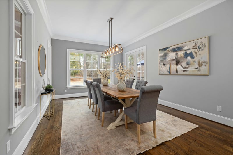 Formal dining room with wood table and large windows in a whole home remodeling project by Managed Renovations in Chevy Chase, M-optimized