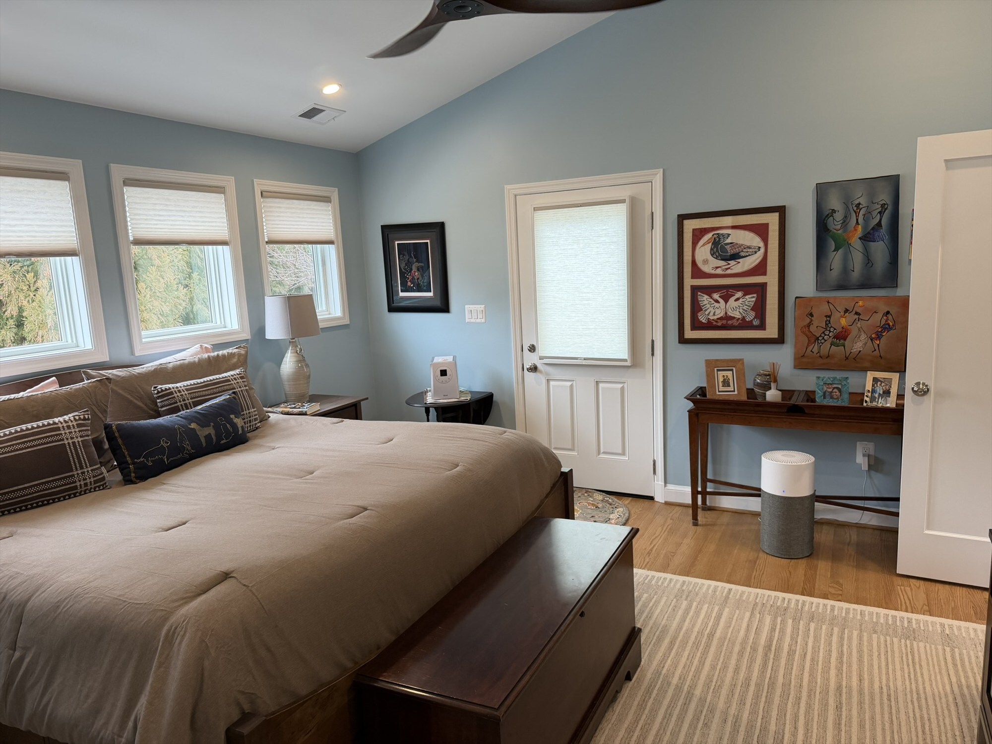 colorful african art gallery wall with door to deck primary bedroom addition - optimized
