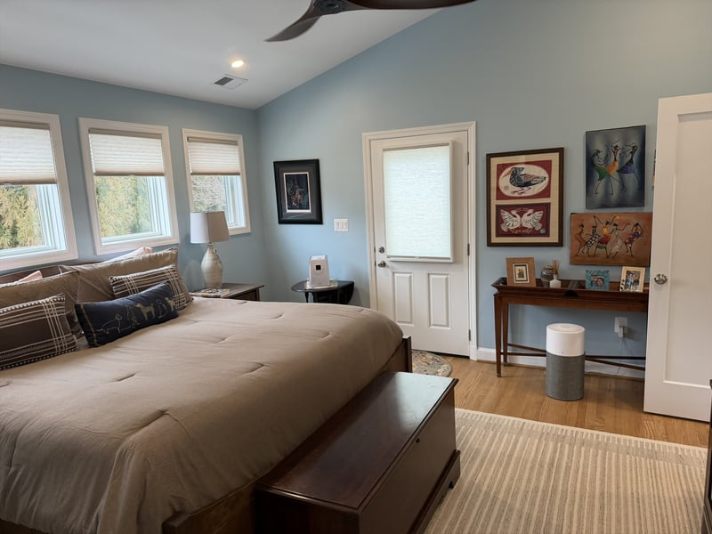 Colorful African art gallery wall with door to deck primary bedroom addition - optimized