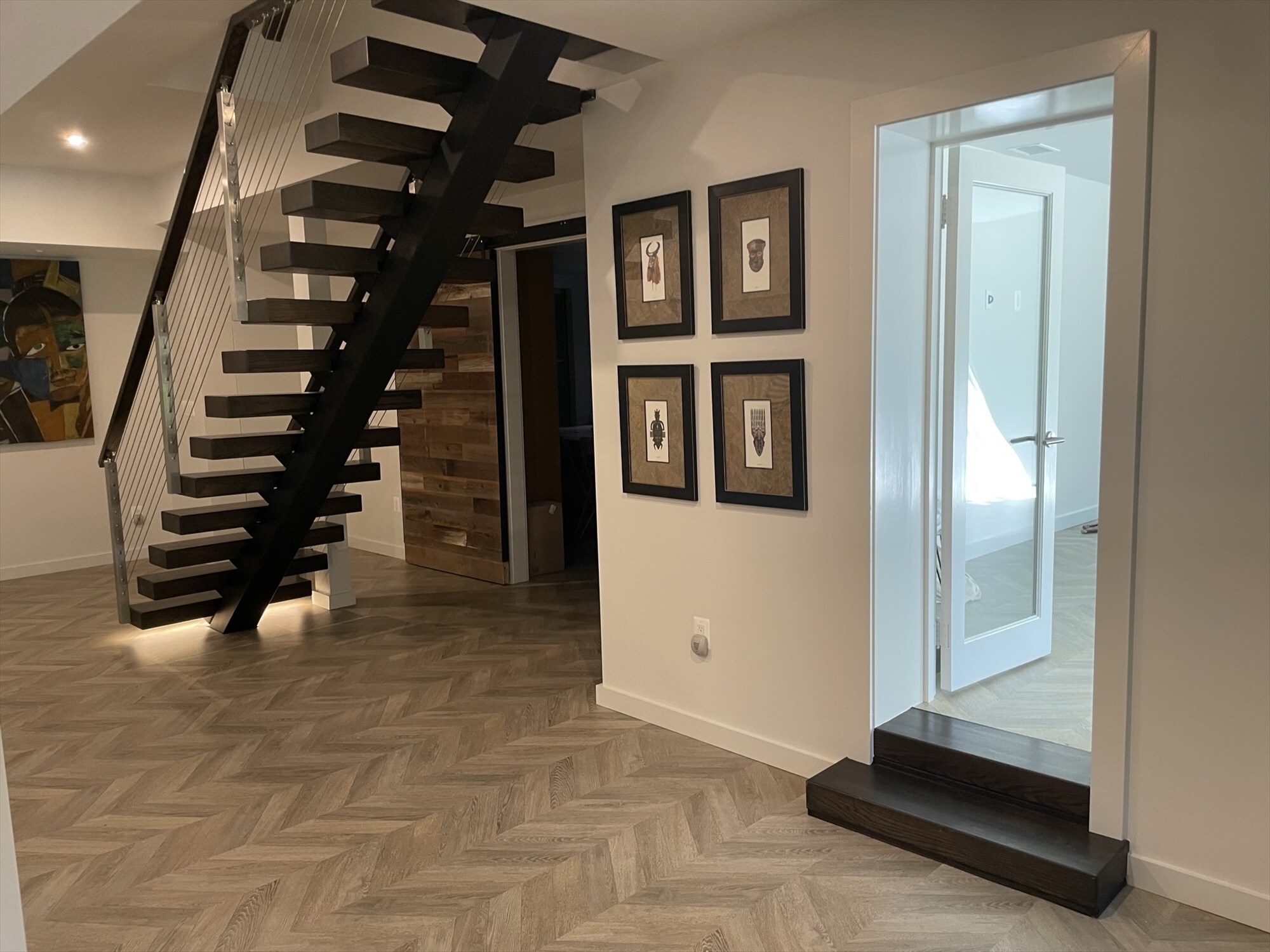 after basement hallway view toward stairs and artwork renovation - optimized