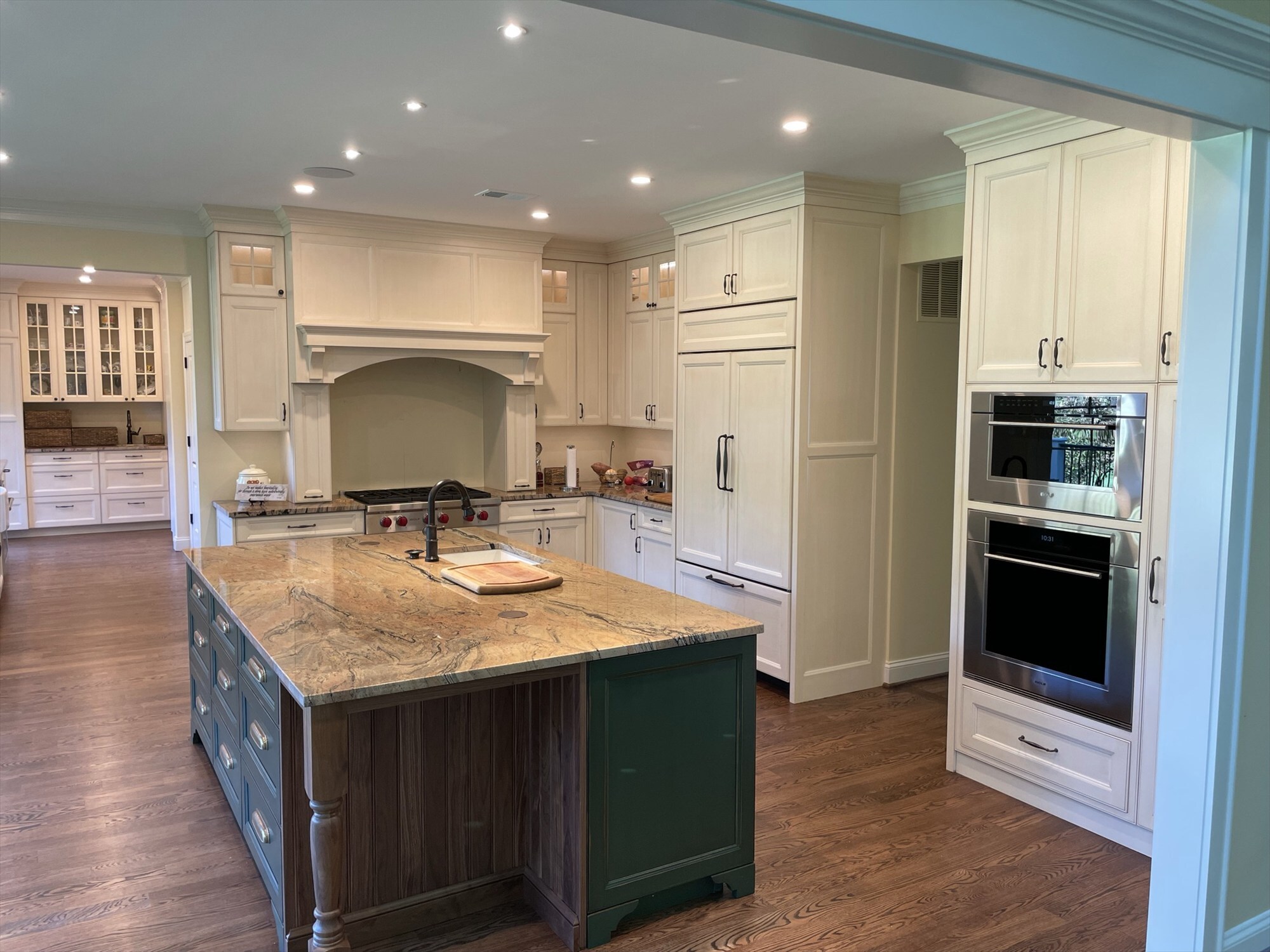 green island with turned legs facing range hood and built in fridge kitchen remodel - optimized