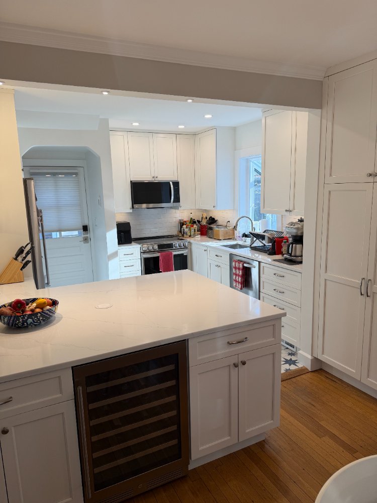 Kitchen remodel in Chevy Chase, MD featuring a large quartz island with an integrated beverage cooler.