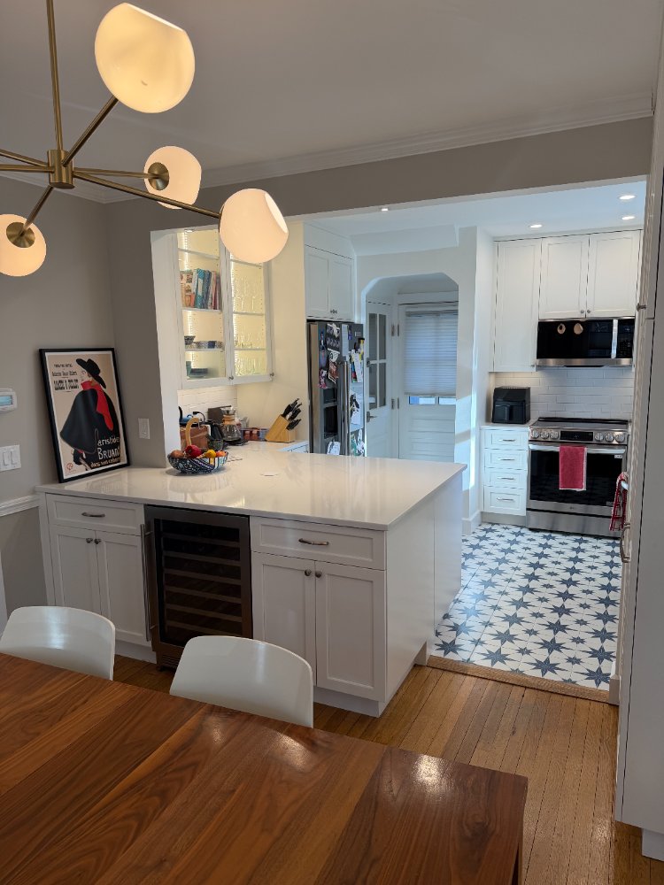 Kitchen remodel in Chevy Chase, MD featuring a quartz island, custom cabinetry, and geometric tile flooring.