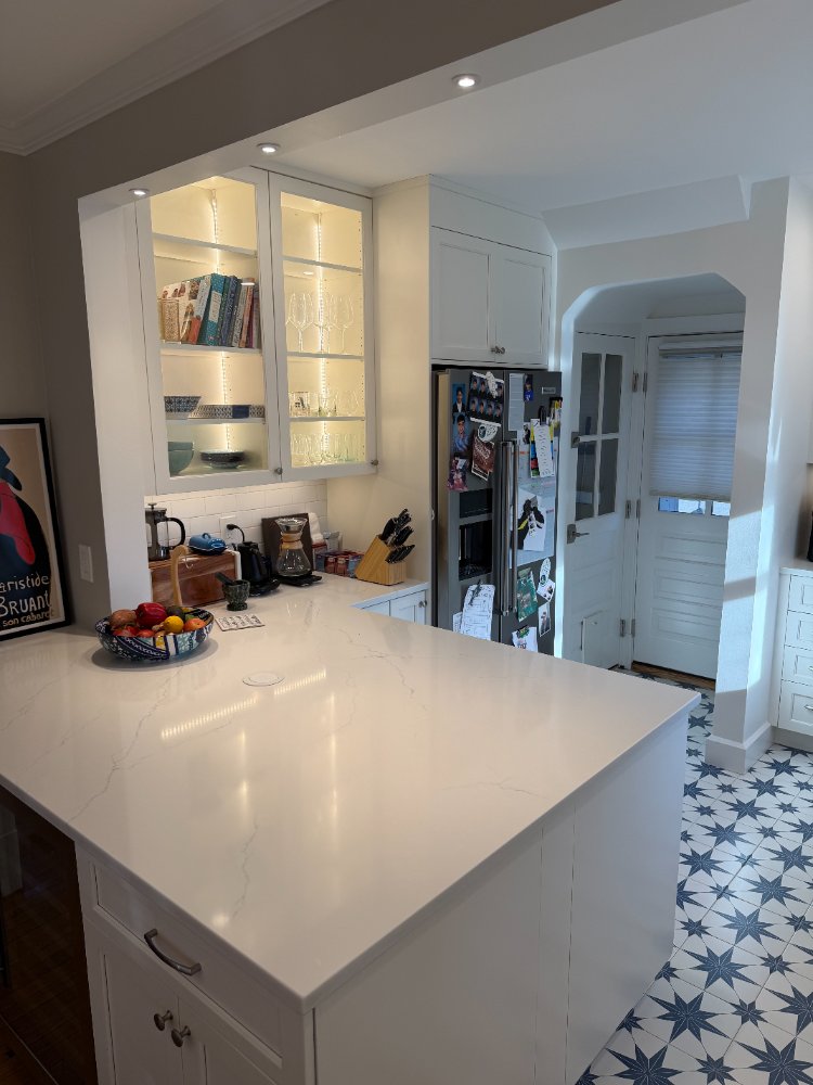 Kitchen remodel in Chevy Chase, MD highlighting a quartz island and stainless steel appliances.