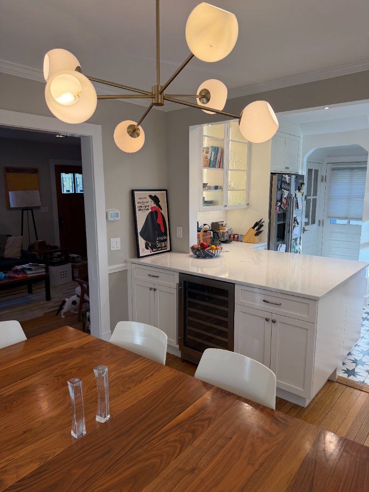 Kitchen remodel in Chevy Chase, MD showcasing a custom dining space with a modern chandelier.
