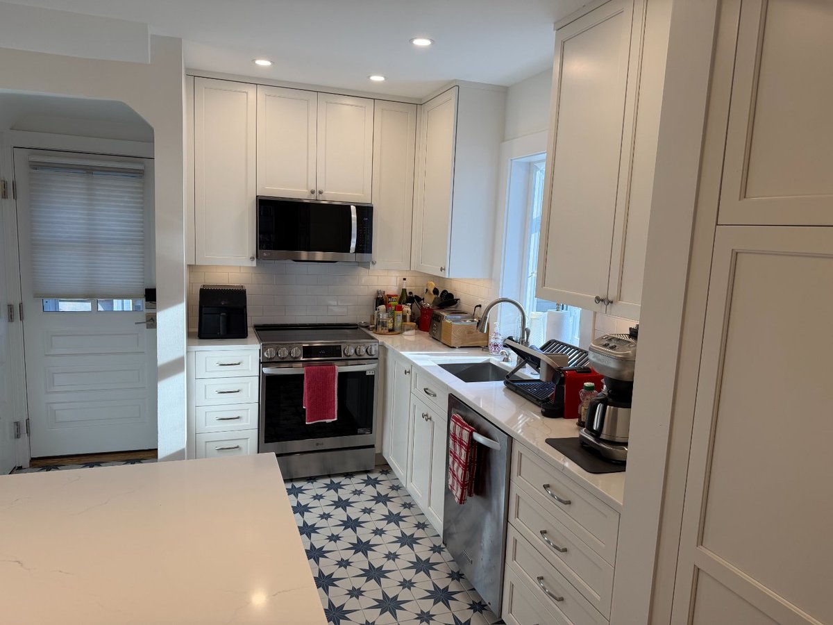 Kitchen remodel in Chevy Chase, MD showcasing a spacious island and illuminated display cabinetry.
