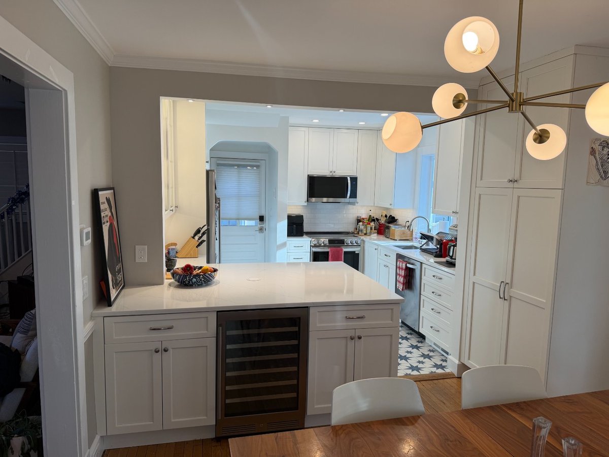 Finished kitchen remodel in Chevy Chase, MD, featuring white shaker cabinets and a quartz island.