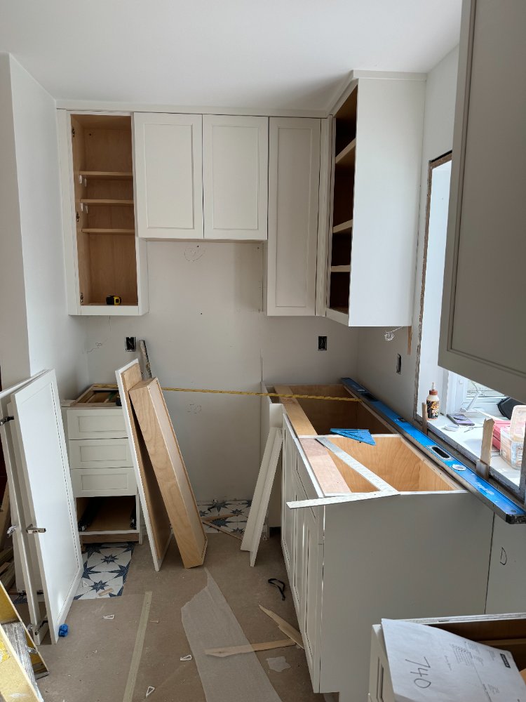 Kitchen cabinetry and base cabinet installation underway during the kitchen remodel in Chevy Chase, MD.