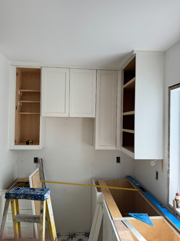 White shaker cabinets being installed during the kitchen remodel in Chevy Chase, MD.