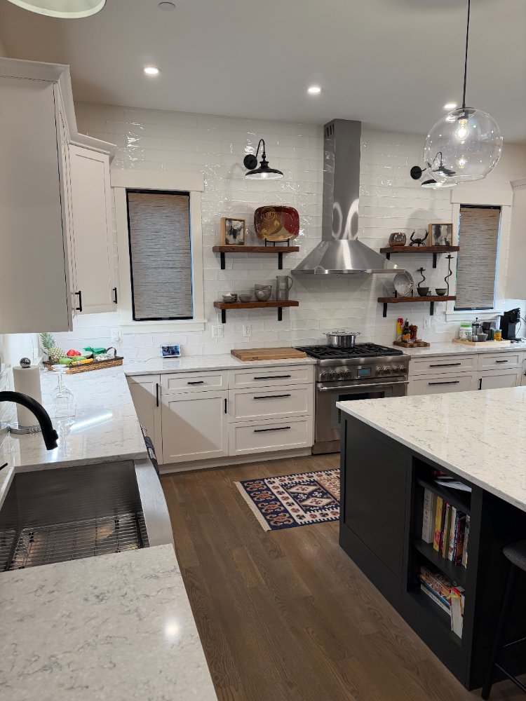 Angled view of the new house custom kitchen in Chevy Chase, MD featuring a spacious island and custom cabinetry.