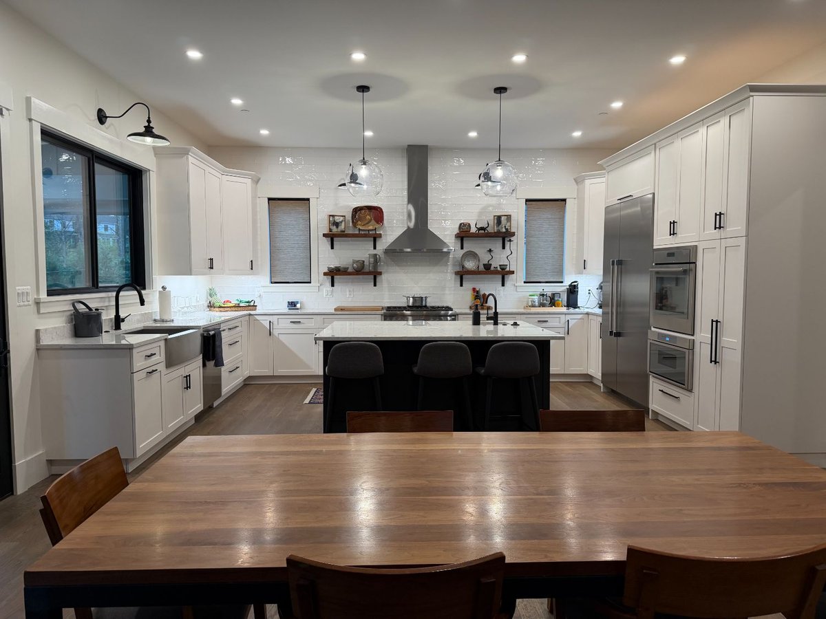 Bright custom kitchen in the new house in Chevy Chase, MD featuring quartz countertops and stainless steel appliances.