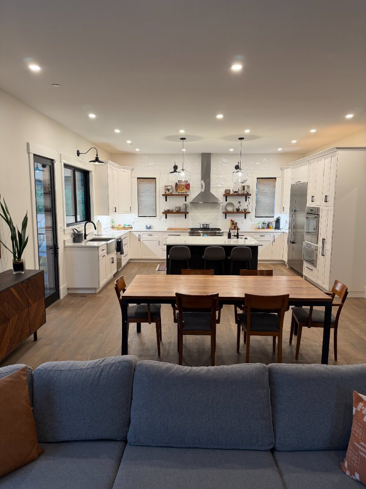 Close-up of the new house custom kitchen in Chevy Chase, MD featuring a quartz island and a built-in oven.
