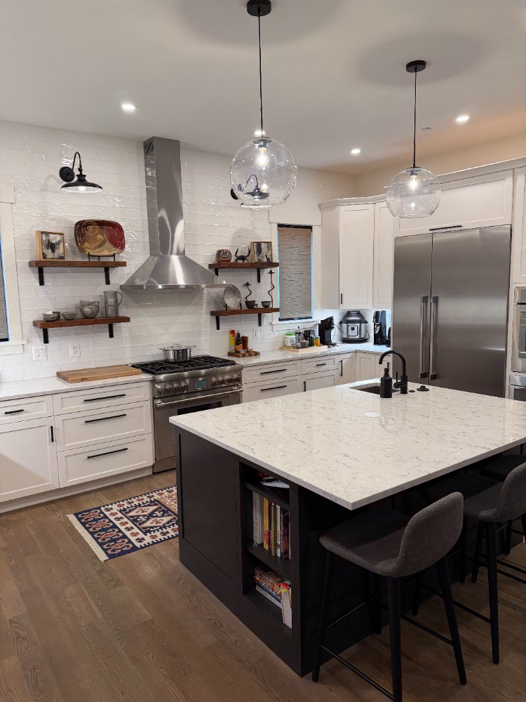 Detailed view of the new house custom kitchen in Chevy Chase, MD with white cabinetry and floating wood shelves.