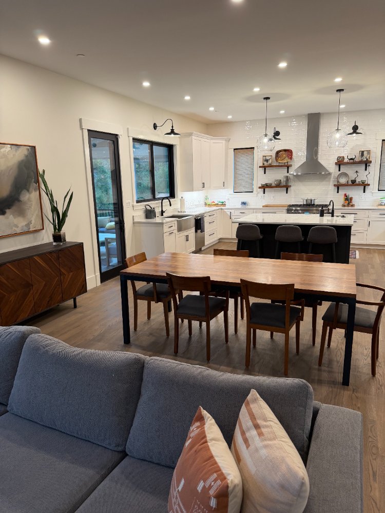 View of the dining area and custom kitchen in Chevy Chase, MD showcasing the new house with a seamless open layout.
