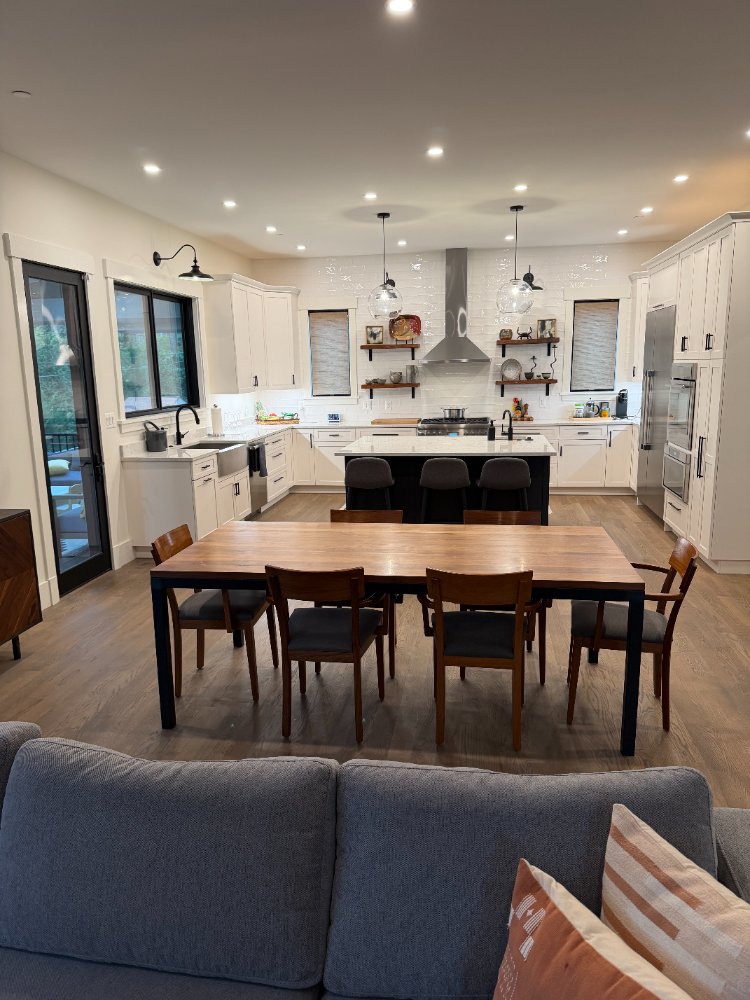 Wide view of the new house custom kitchen and dining area in Chevy Chase, MD with an oversized island.