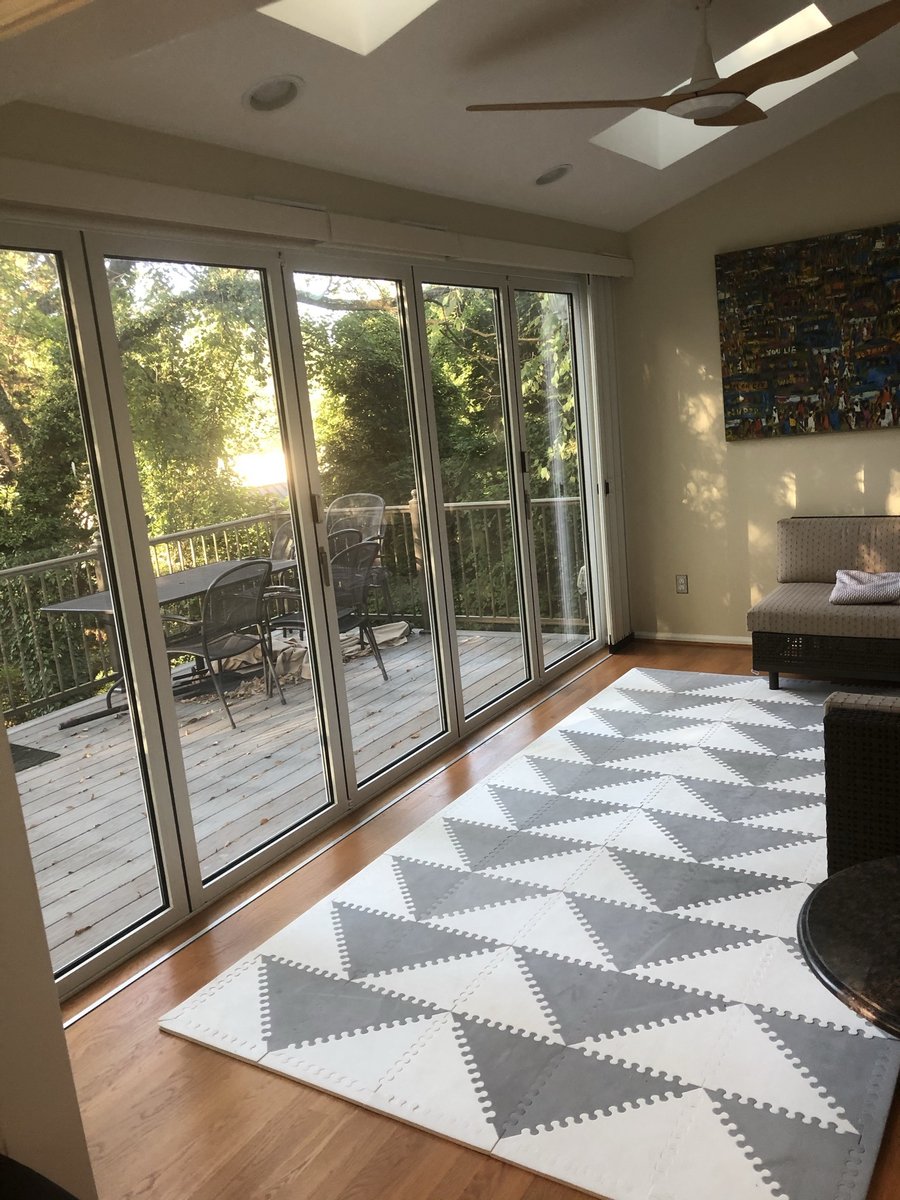 sunroom with glass doors and wooded deck view in chevy chase md sunroom and deck addition