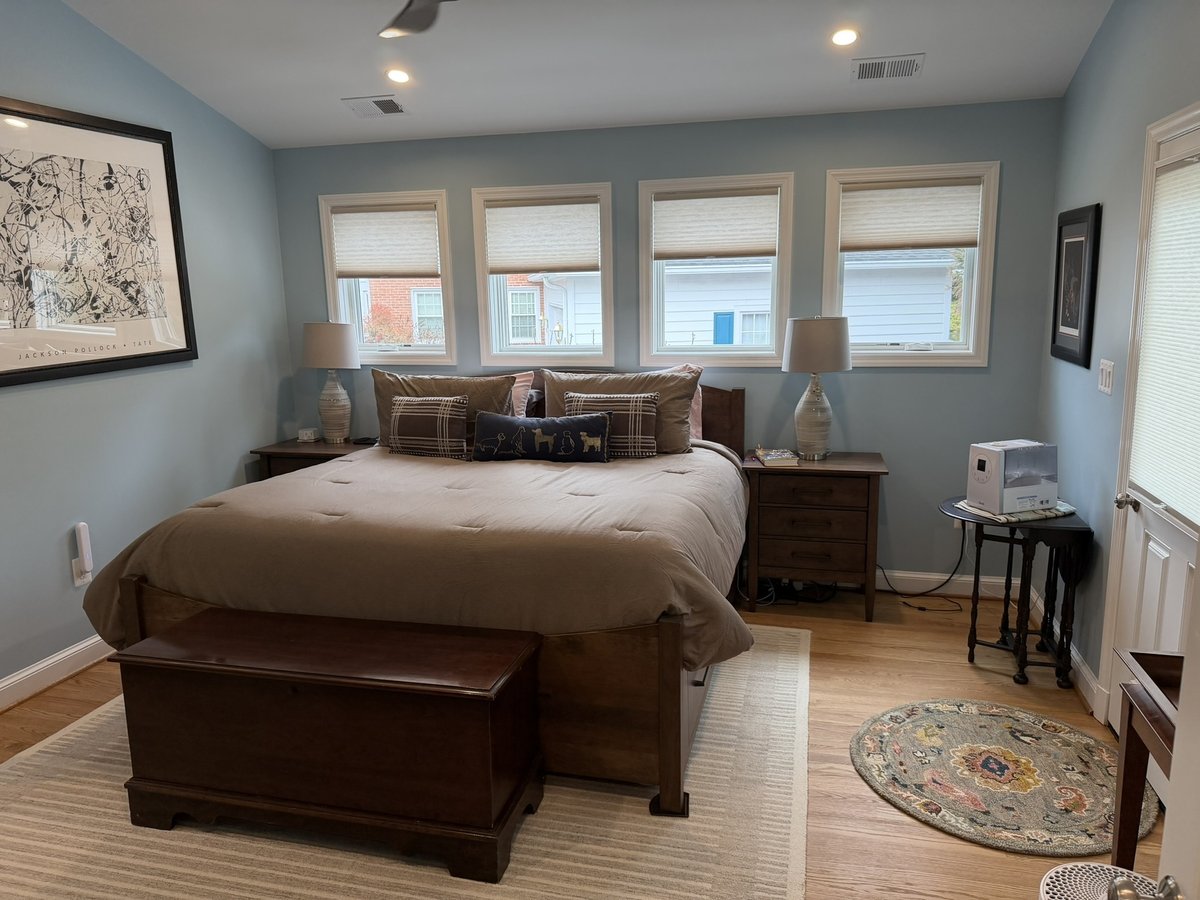 primary suite addition bedroom with hardwood floors multiple windows and ceiling fan in chevy chase md