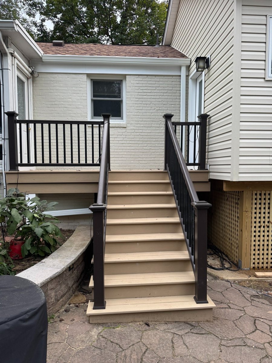 primary suite addition exterior deck stairs with black railing in chevy chase md