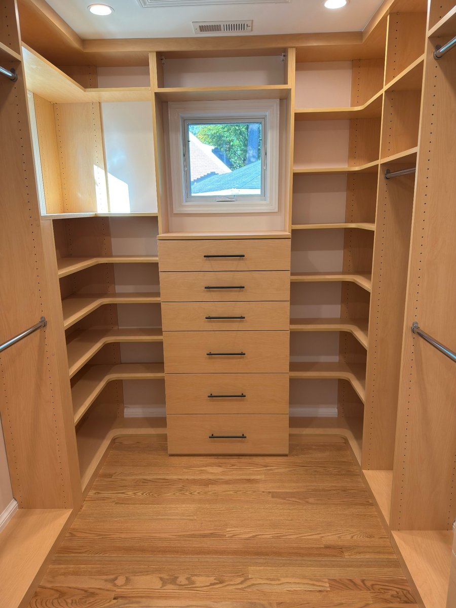 primary suite addition walk in closet with custom wood storage and window in chevy chase md