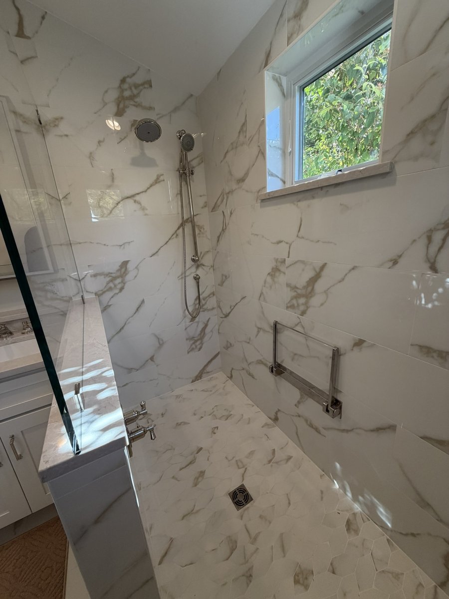 primary suite addition walk in shower with marble tile rainfall fixture and window in chevy chase md