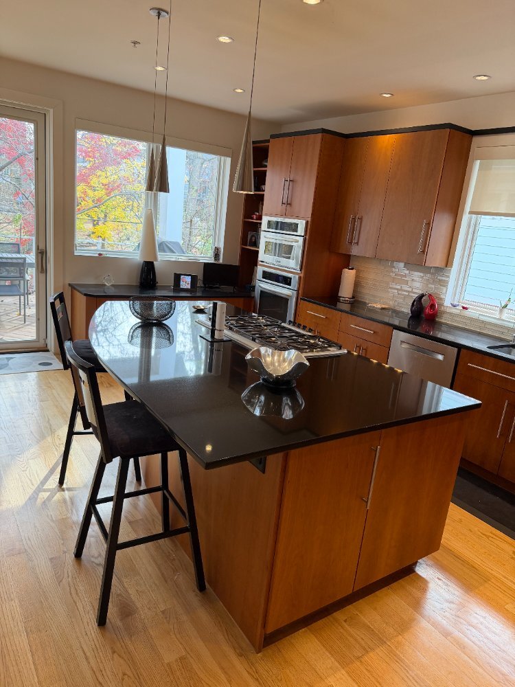 New house kitchen in Chevy Chase, MD featuring pendant lighting, stainless steel appliances, and a spacious layout.