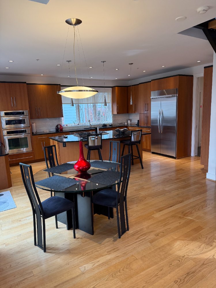 Modern Chevy Chase, MD kitchen with an oversized island and open-concept dining area.