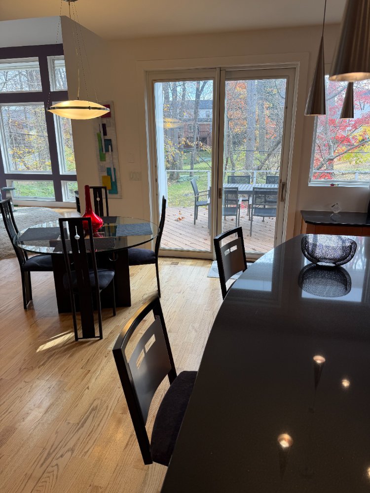 Modern Chevy Chase, MD kitchen with black stone countertops and open dining space.