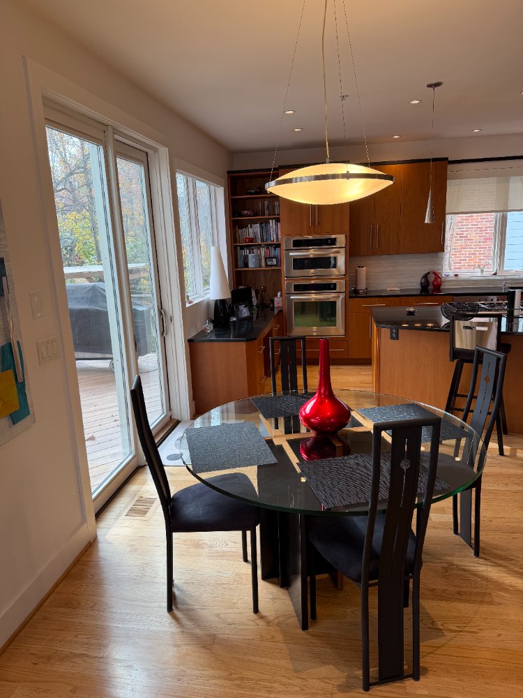 Modern kitchen and dining area in the new house in Chevy Chase, MD, featuring custom wood cabinetry.