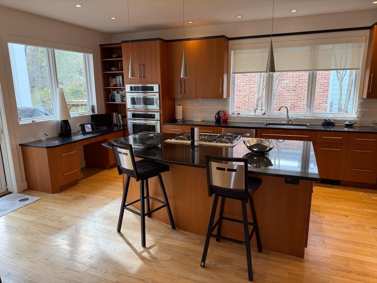 Spacious custom kitchen in Chevy Chase, MD with a large center island, wood cabinetry