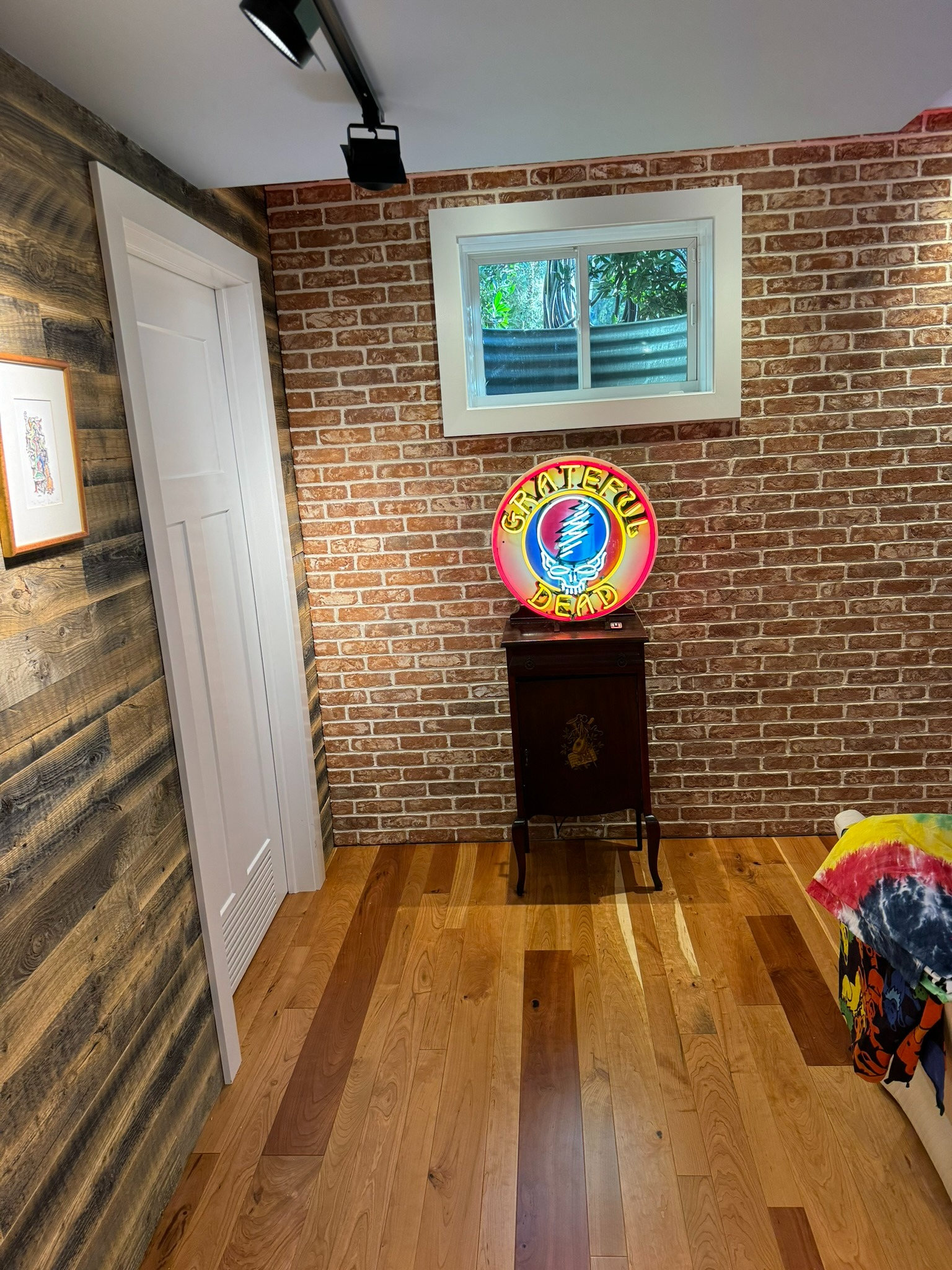 completed office remodel in Cabin John, MD featuring brick accent wall reclaimed wood paneling hardwood floors window and gratef