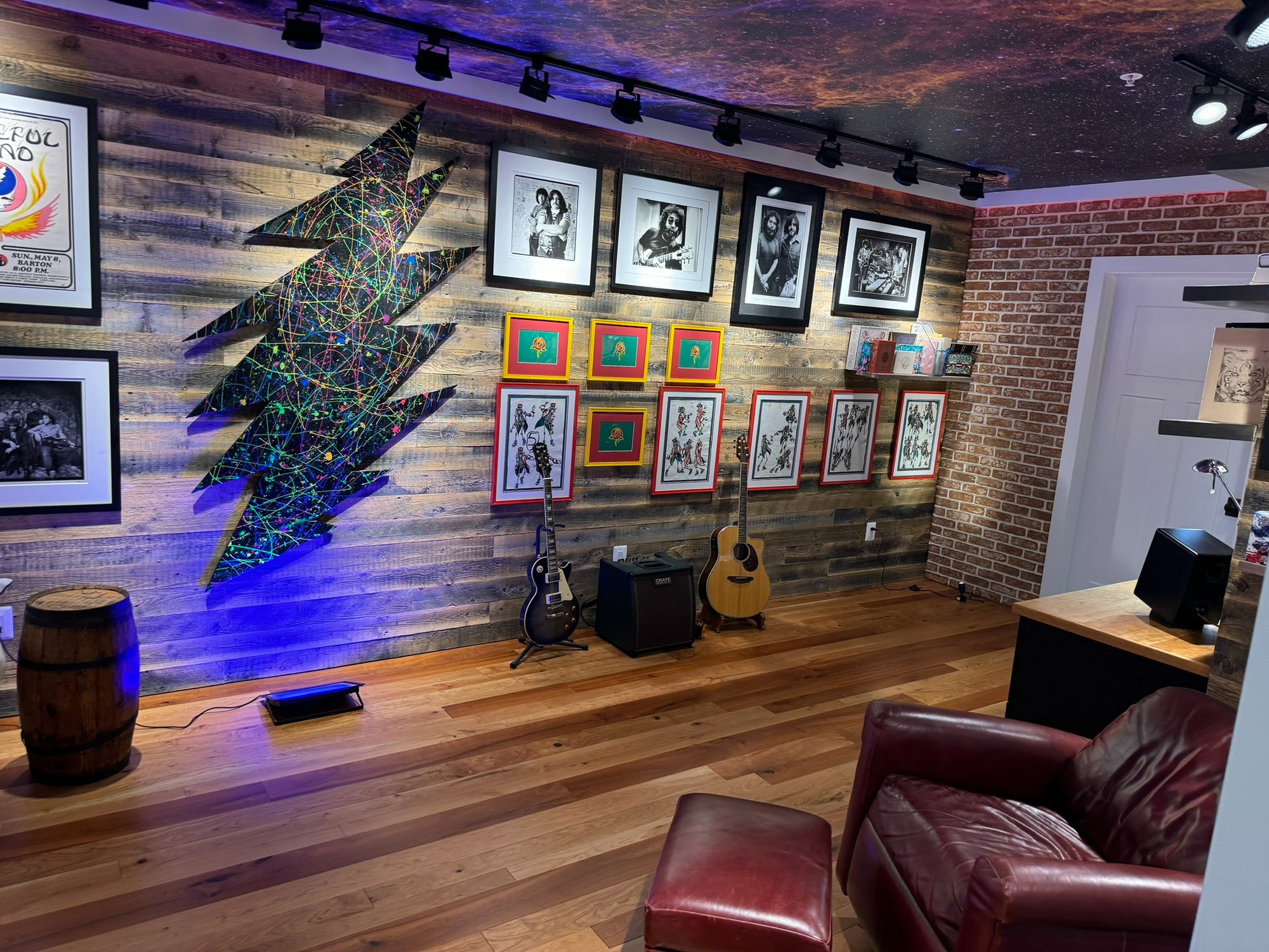 completed office remodel in Cabin John, MD with reclaimed wood gallery wall colorful lightning bolt art guitars brick accents an
