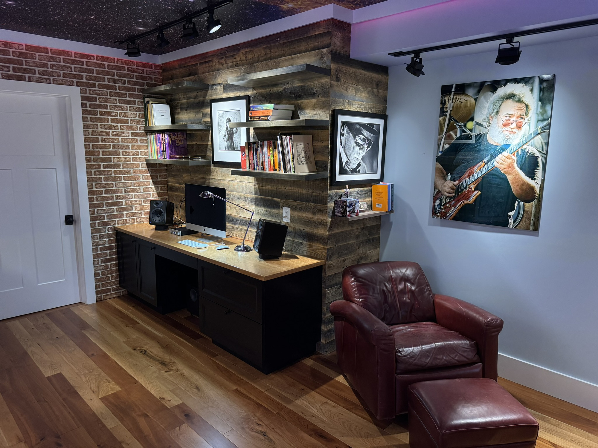 office remodel in Cabin John, MD featuring custom workspace reclaimed wood shelves brick accent wall leather chair and hardwood