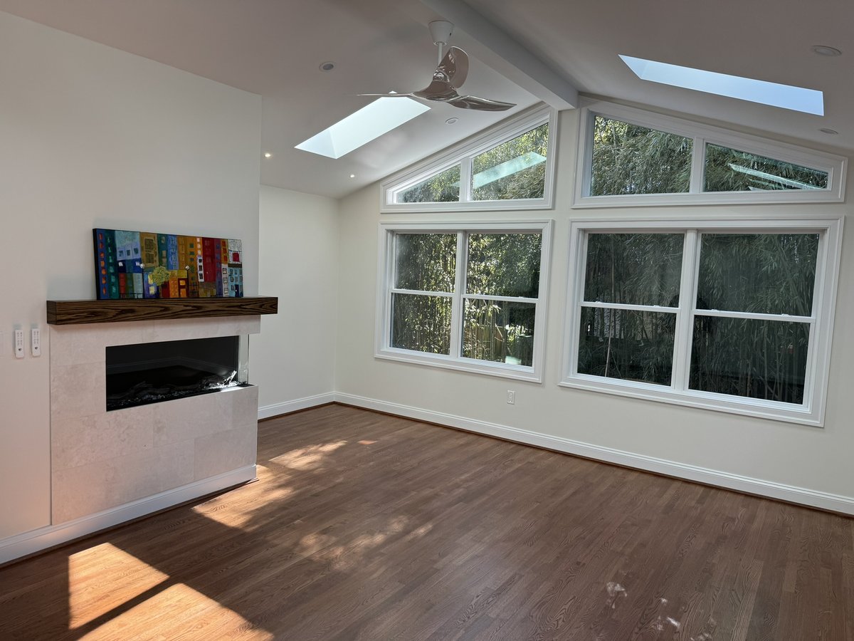 chevy chase md addition interior with vaulted ceiling skylights fireplace and large windows