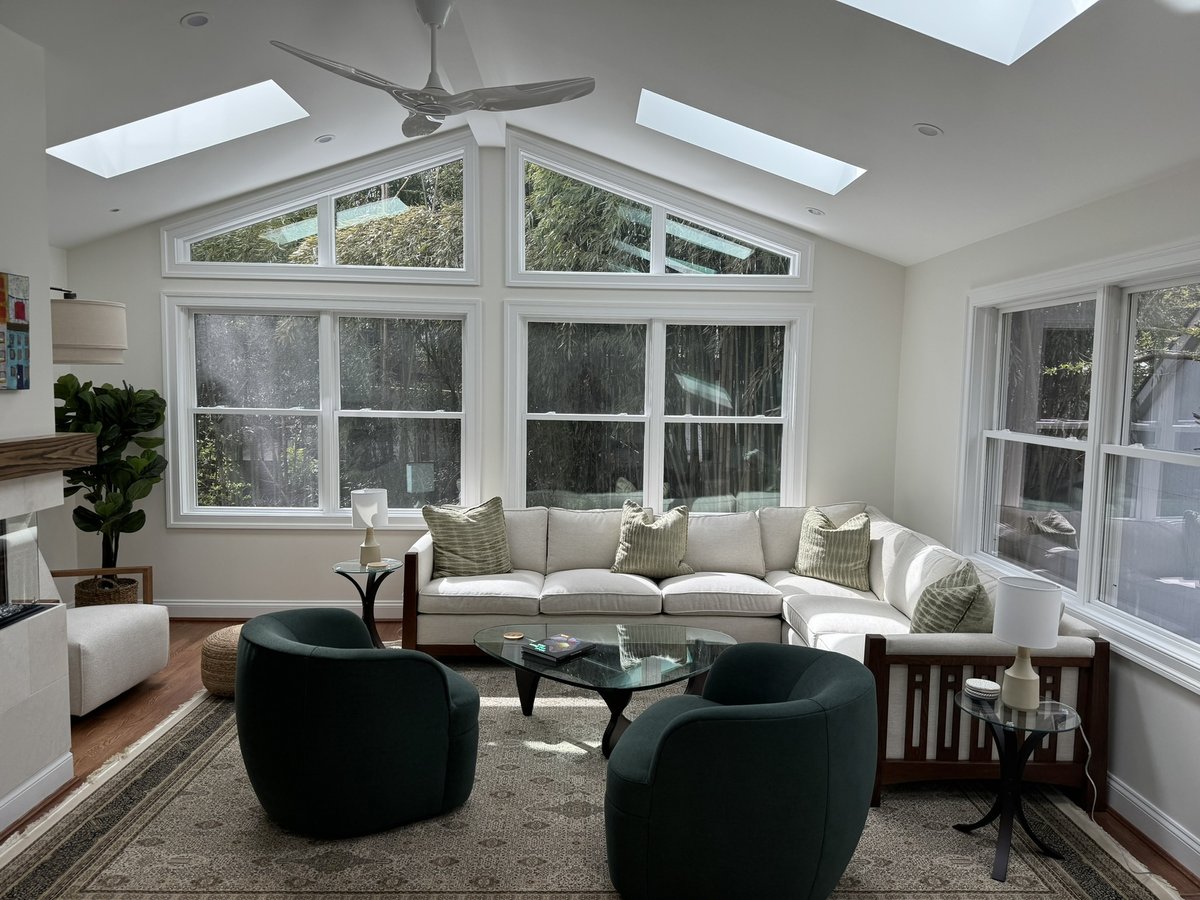 chevy chase md addition living room with sectional sofa green chairs skylights and large windows
