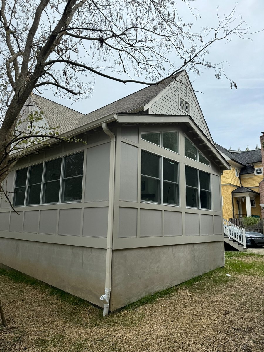 gray gable roof home addition with expansive windows and board and batten siding in chevy chase md