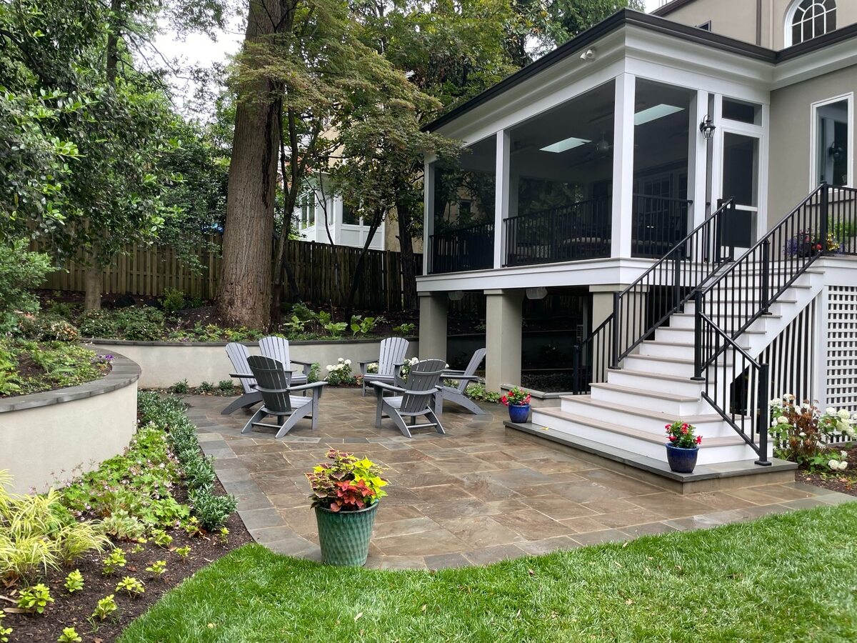 addition and exterior hardscaping with elevated screened porch stone patio and outdoor seating in chevy chase md