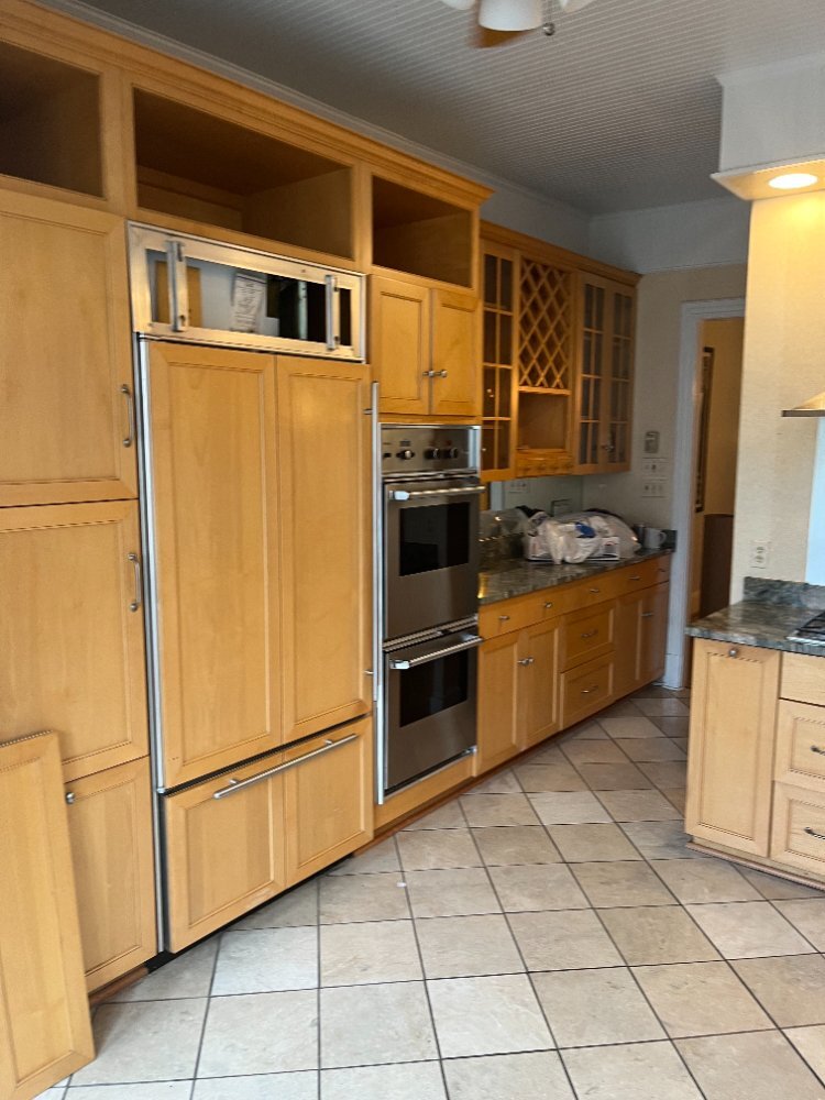 Original kitchen with wood cabinets and built-in appliances before renovation in Northwest Washington, D.C.