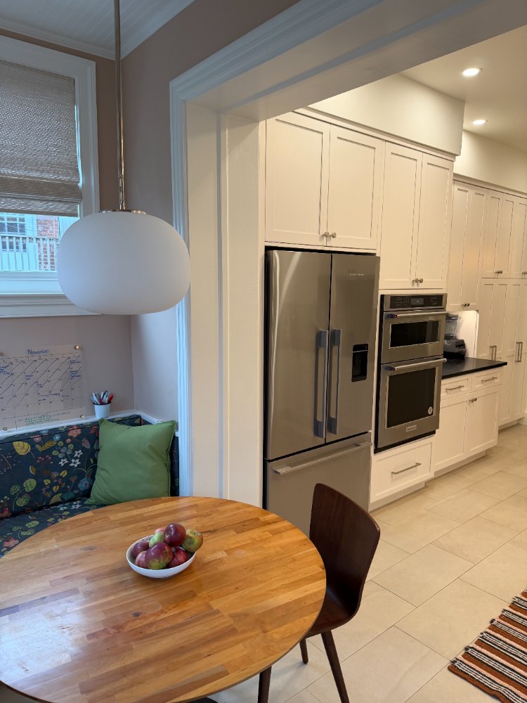 View into a remodeled kitchen featuring custom cabinetry, stainless steel appliances, and a breakfast nook.