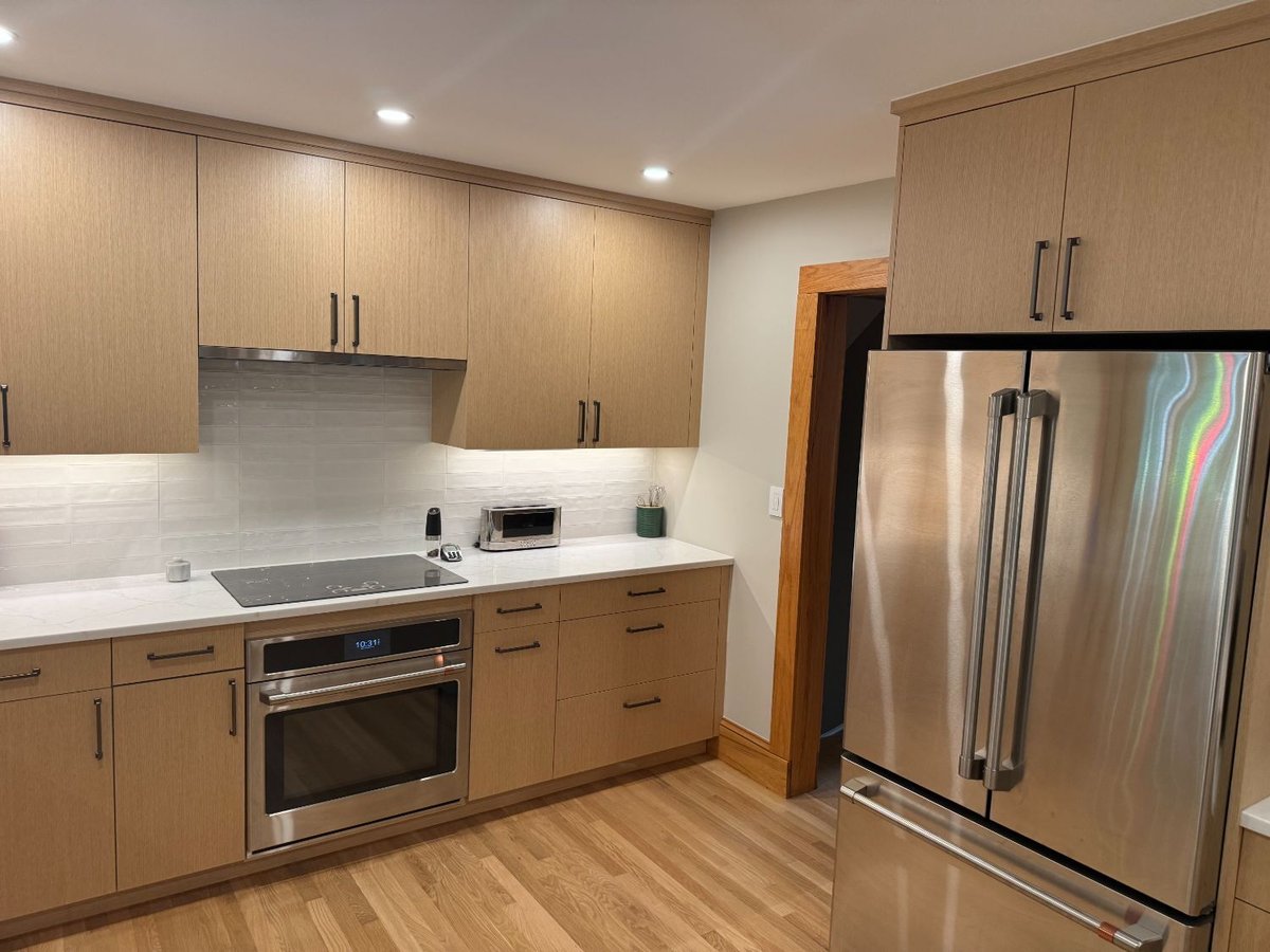 After view of the remodeled kitchen with custom cabinetry and quartz countertops in Kensington, MD.