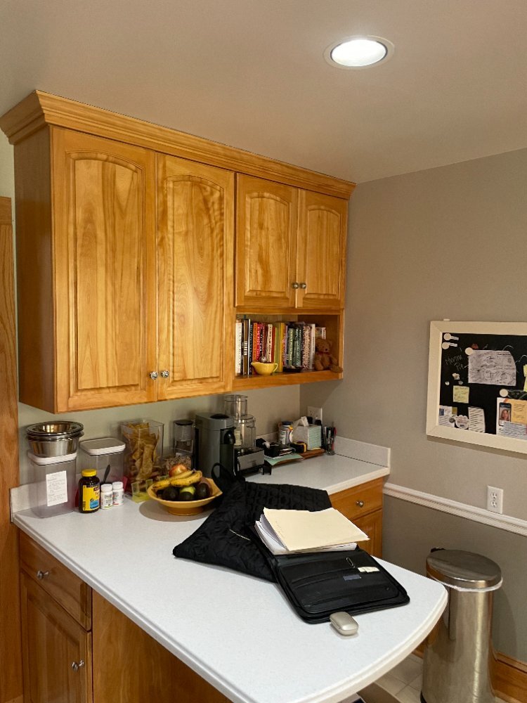 Existing kitchen peninsula with wood cabinetry before a kitchen renovation in Kensington, MD.