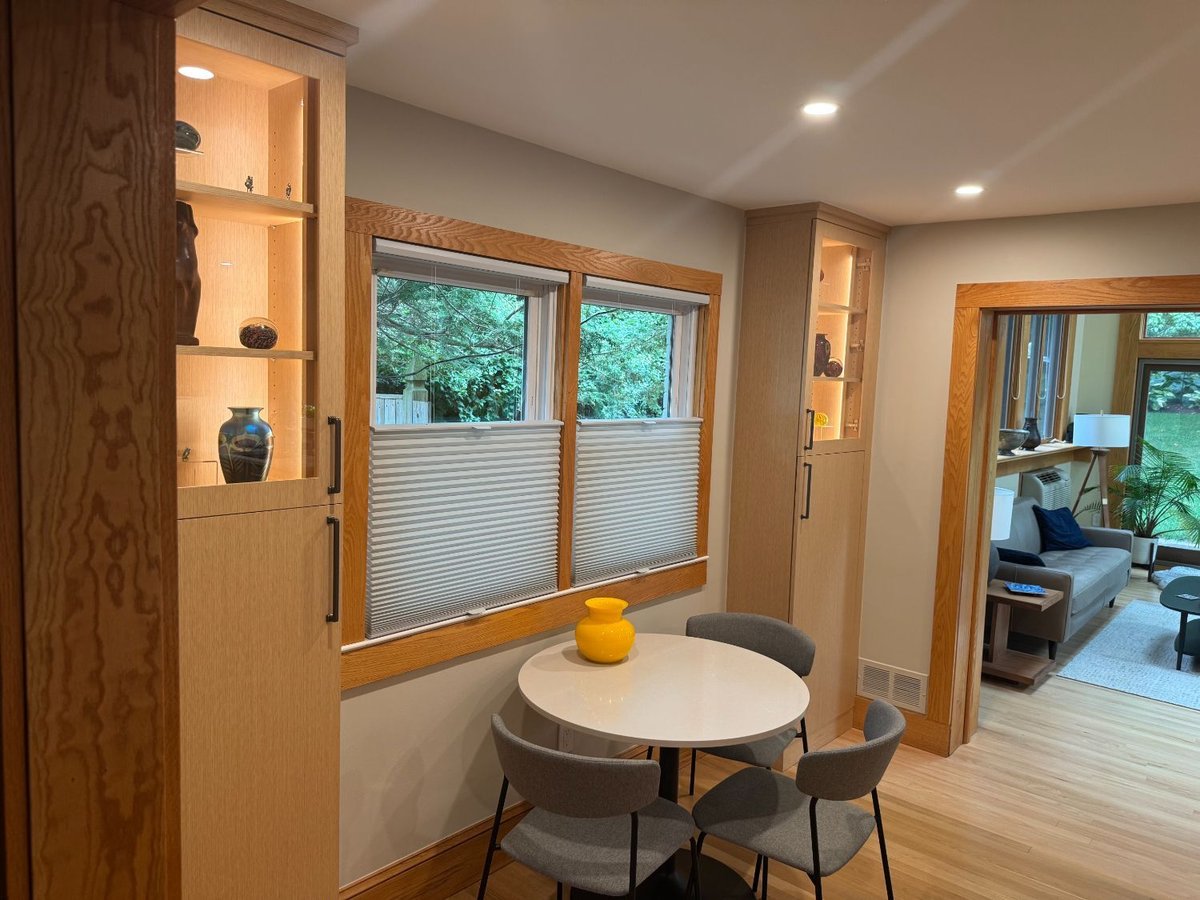 Modern breakfast area featuring built-in display cabinetry after a kitchen remodel in Kensington, MD.