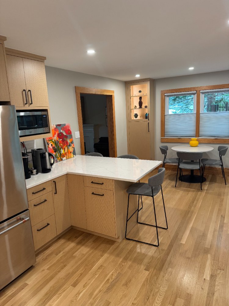 Quartz waterfall peninsula and custom cabinetry in a Kensington, MD kitchen remodel.