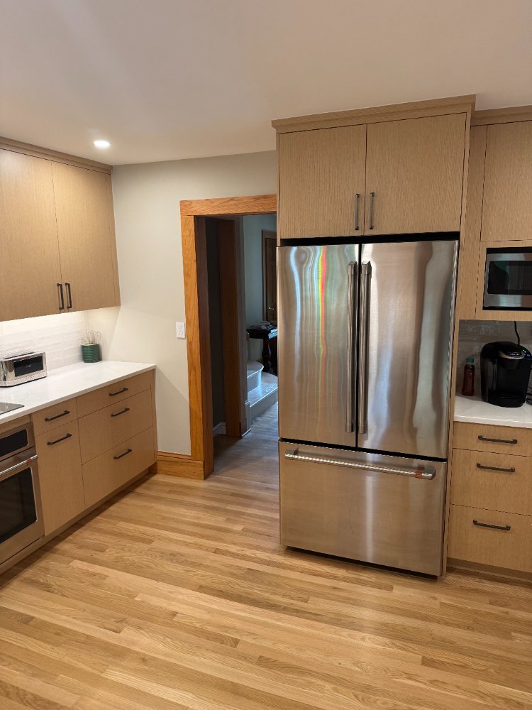 Stainless steel refrigerator with surrounding custom cabinetry in a Kensington, MD kitchen remodel.