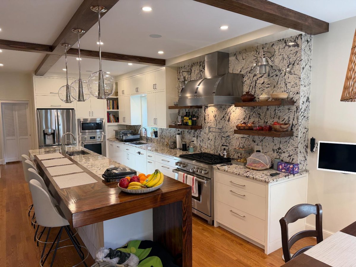 Completed Kitchen remodel in Northwest Washington, D.C. featuring custom white cabinetry, wood beams