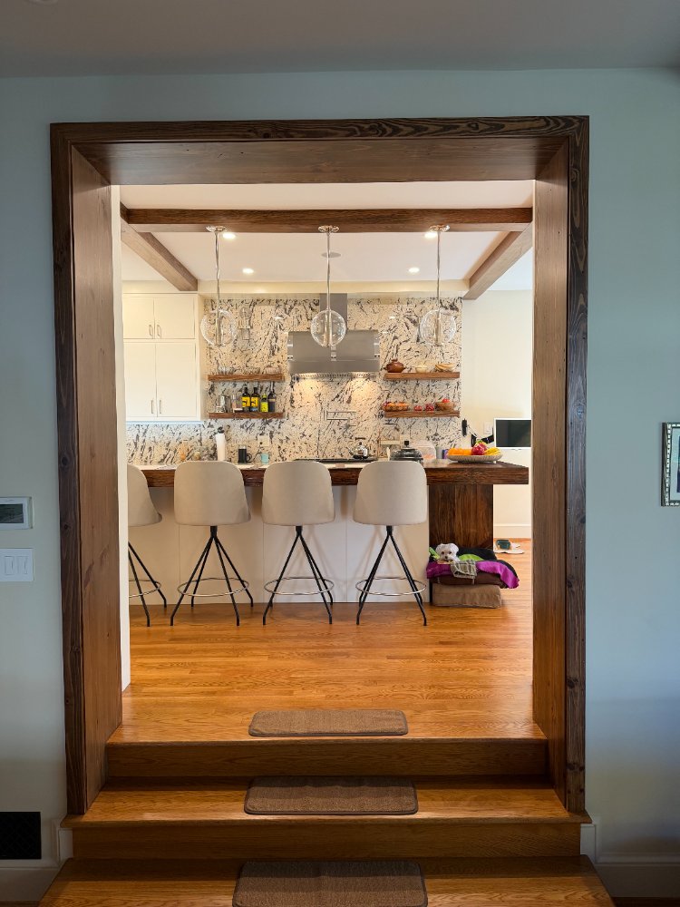 Custom kitchen remodel viewed through a wood-trimmed opening in Northwest Washington, D.C.