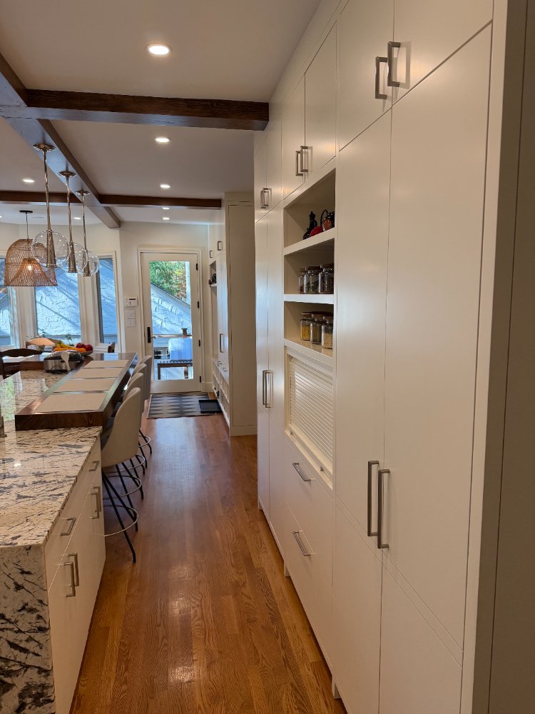 Floor-to-ceiling white cabinetry with integrated storage in a kitchen renovation in Northwest Washington, D.C.