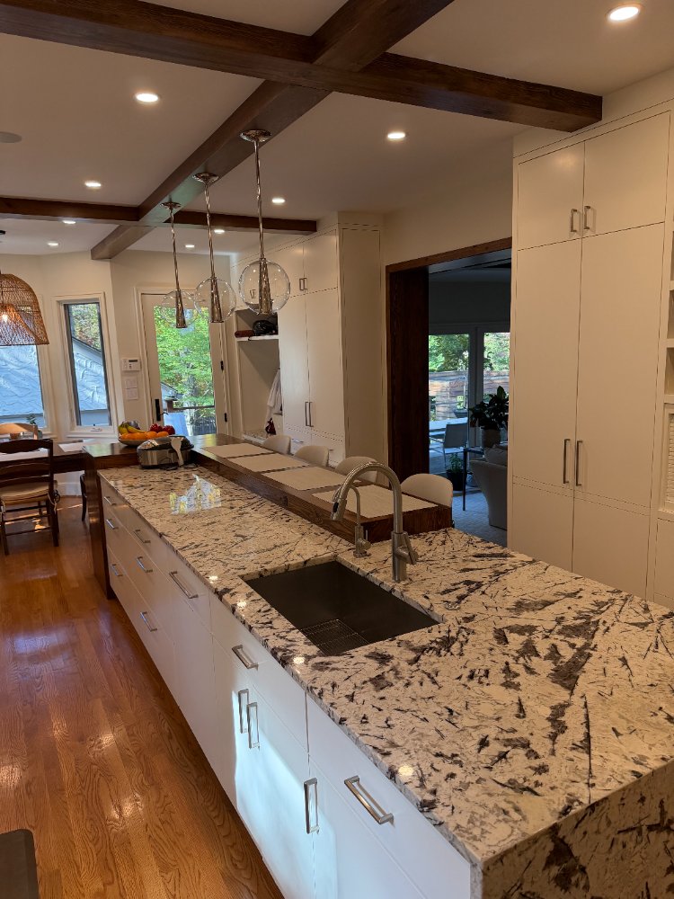 Large waterfall island with integrated sink in a custom kitchen remodel in Northwest Washington, D.C.