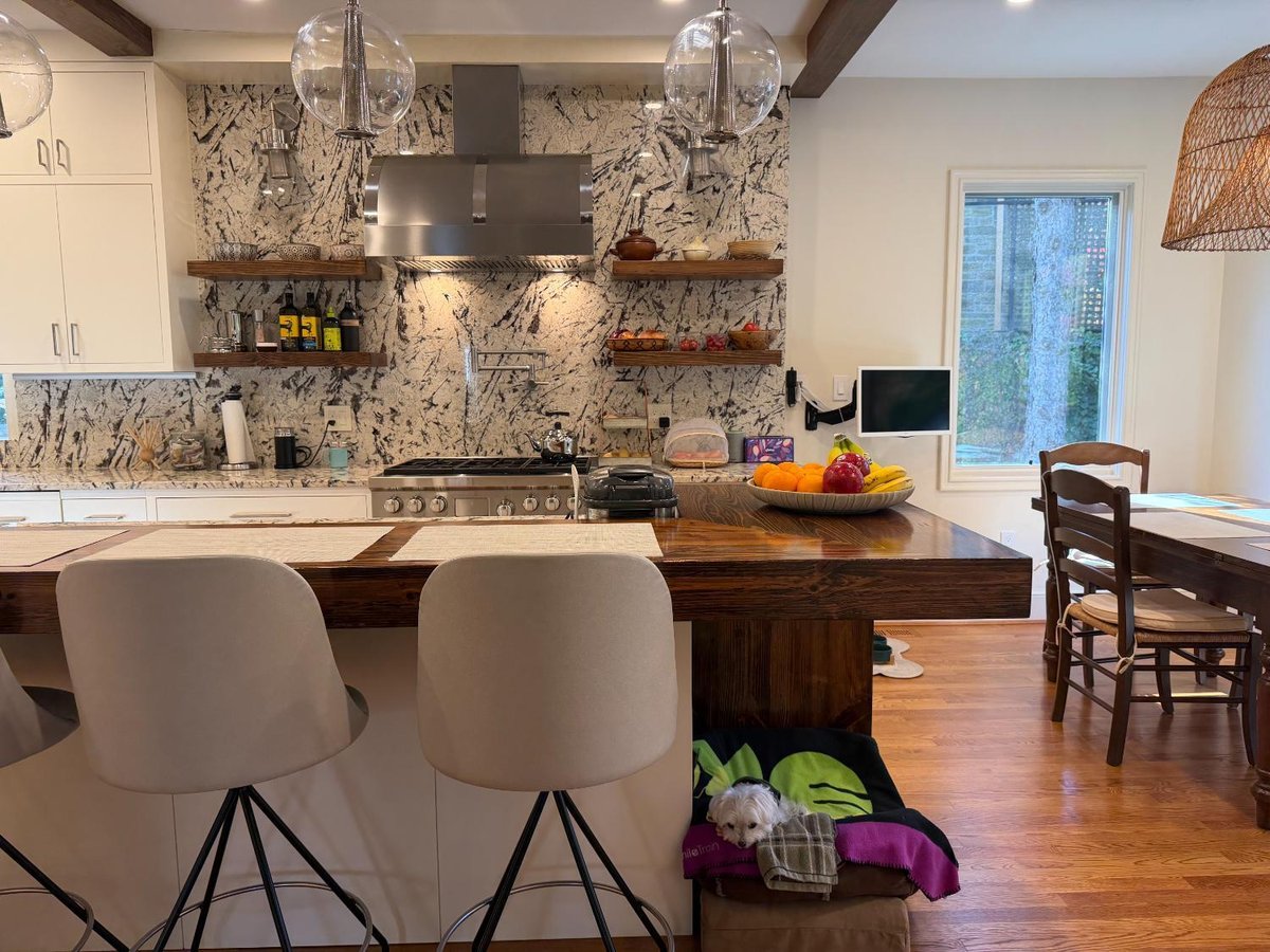 Luxury Northwest Washington, D.C. kitchen renovation with custom cabinetry, stainless steel appliances, and a dramatic stone feature.