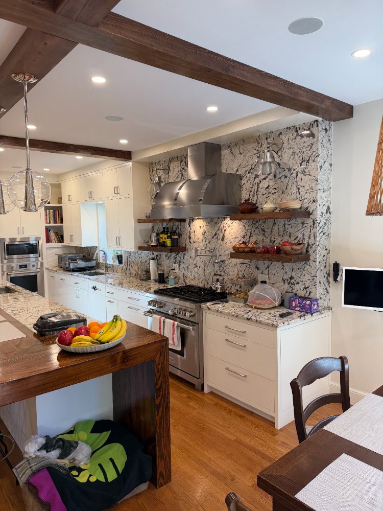 Luxury kitchen remodel in Northwest Washington, D.C. with custom white cabinets and floating shelves.
