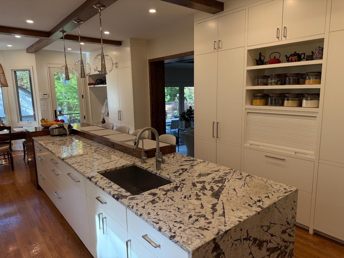Luxury kitchen remodel in Northwest Washington, D.C. with expansive cabinetry, stone surfaces, and integrated appliances.
